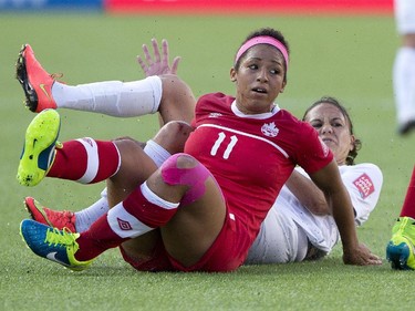 Canada's Desiree Scott (11) and New Zealand's Amber Hearn (9) get tangled up during FIFA World Cup during first half action in Edmonton, Alta., on Thursday June 11, 2015.