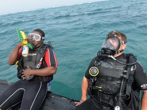 SAN PEDRO, Belize - Leading Seaman Drew Griffith, (R) Royal Canadian Navy, and Ensign Charles Francisco of the Belize coast guard prepare to enter the water to begin a circular search dive together during the maritime, phase II of the Tradewinds 2015 exercise. Tradewinds is a combined, joint U.S. Southern Command-sponsored exercise and an opportunity for the participating partner nations to come together to enhance regional maritime security. (U.S. Navy photo by Mass Communication Specialist 1st Class (SW) Dan Meaney/Released)