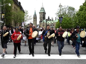 Drummers pass Parliament Hill as they lead the Walk for Reconciliation, part of the closing events of the Truth and Reconciliation Commission on Sunday, May 31, 2015 in Ottawa.