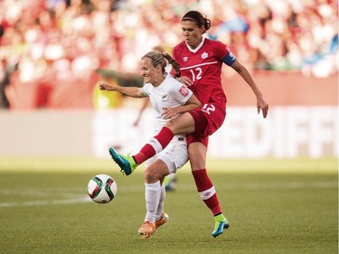New Zealand's Katie Duncan (L) and Canada's Christine Sinclair vie for the ball during their Group A match at the FIFA Women's World Cup at Commonwealth Stadium in Edmonton, Canada on June 11, 2015.