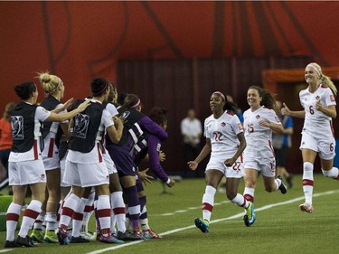 Canada's Ashley Lawrence (3rd R) celebrates with the bench after scoring against the Netherlands' during a 2015 FIFA Women's World Cup Group A match at the Olympic Stadium in Montreal on June 15, 2015.