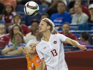 Canada's Sophie Schmidt (R) and the Netherlands' Vivianne Miedima fight for the ball during a 2015 FIFA Women's World Cup Group A match at the Olympic Stadium in Montreal on June 15, 2015.