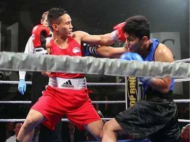 From left, amateur boxer Cedric Parina from Ottawa's Beaver Boxing Club fights Kunal Pun from the Mississauga-based Kombat Arts at Ringside for Youth XXI, held at the Shaw Centre on Thursday, June 11, 2015.