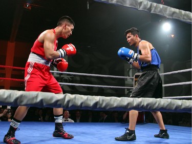 From left, amateur boxer Cedric Parina from Ottawa's Beaver Boxing Club fights Kunal Pun from the Mississauga-based Kombat Arts training academy before a crowd of 1,400 at Ringside for Youth XXI, held at the Shaw Centre on Thursday, June 11, 2015.