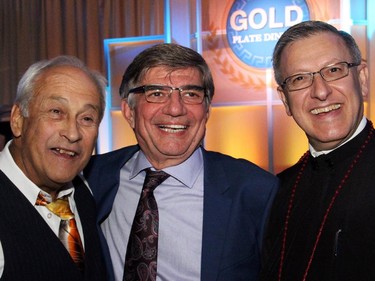 From left, Peter Foustanellas from title sponsor Argos Carpets & Flooring and Olympia Homes, with Gold Plate Dinner chair Steve Ramphos and Fr. Alex Michalopulos at this year's fundraising dinner, held Tuesday, June 9, 2015, at the Hellenic Meeting and Reception Centre.
