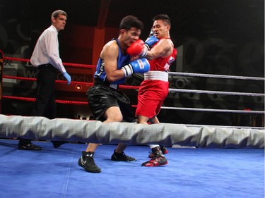 From right, amateur boxer Cedric Parina from Ottawa's Beaver Boxing Club fights Kunal Pun from the Mississauga-based Kombat Arts at Ringside for Youth XXI, held at the Shaw Centre on Thursday, June 11, 2015.