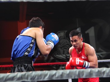 From right, amateur boxer Cedric Parina from Ottawa's Beaver Boxing Club fights Kunal Pun from the Mississauga-based Kombat Arts at Ringside for Youth XXI, held at the Shaw Centre on Thursday, June 11, 2015.