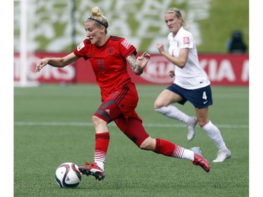 Germany' 's Anja Mittag (11) carries the ball upfield while Norway's Gry Tofte IMS (4) looks on during the first half of their match during the 2015 FIFA Women's World Cup at Lansdowne Stadium Thursday June 11, 2015.
