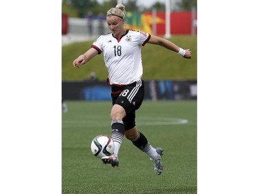 Germany's Alexandra Popp (18) carries the ball upfield against Cote d'Ivoire during the first half of their first match of the FIFA Women's World Cup at TD Place in Ottawa Saturday June 07, 2014.