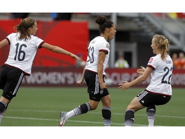 Germany's Celia Sasic (13) celebrates her goal against Cote d'Ivoire with Melanie Leupolz (16) and Tabea Kemme (22) during the FIFA Women's World Cup at TD Place in Ottawa Sunday June 07, 2015.