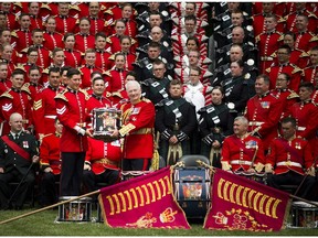 Governor General and Commander-in Chief David Johnston was presented with a drum after a group photograph with members of The Ceremonial Guard on the grounds of Rideau Hall the official residence of the Governor General, in Ottawa, Saturday June 27, 2015. ( Ashley Fraser / Ottawa Citizen )