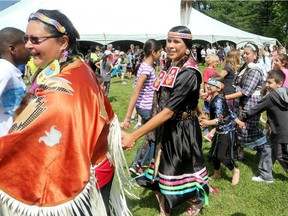 Groups of children take part in a Pow Wow dance.  The first half of six thousand elementary schoolchildren poured into Vincent Massey Park Thursday for National Aboriginal Day, where they learned about native culture through demonstrations, games and interactive workshops.