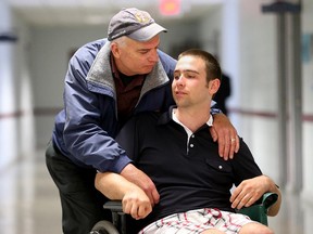 Justin McKenna, pictured at Neuro Gym Rehabilitation with his dad, Gerry McKenna, suffered a serious brain injury in a 2007 ATV accident at the age of 17.  Now 25, he will be one of the participants in the upcoming Brain Injury Awareness Walk in Ottawa on June 20.