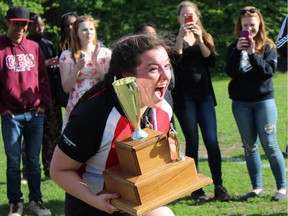 Katia Maxwell-Campagne with the Gloucester High School Gators celebrates after receiving the first-place trophy in the NCSSAA Senior Girls Tier 2 Rugby Championships on Tuesday.