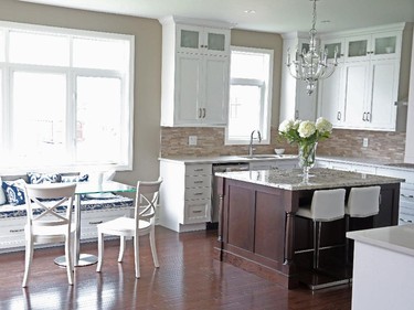 Intriguing touches include a banquette with storage in the kitchen’s bright breakfast area.