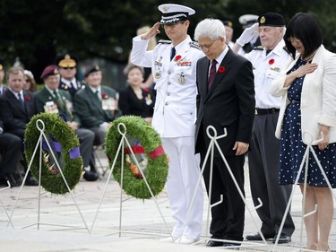Korean ambassador Daeshik Jo and senator Yonah Martin pays respect at the 62nd anniversary of the Korean War Armistice at War Memorial in Ottawa on Sunday, June 21, 2015.