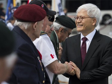 Korean ambassador Daeshik Jo greets the veterans at the 62nd anniversary of the Korean War Armistice at War Memorial in Ottawa on Sunday, June 21, 2015.