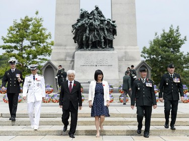 (L-R) Member of the Canadian Force, Korean military attache, colonel Jang Min Choi, Korean ambassador Daeshik Jo, senator Yonah Martin, Lieutenant General Marquis Haines, and Chief Warrant Officer Alain Guimond walk down the stairs as the ceremony ends for the 62nd anniversary of the Korean War Armistice at War Memorial in Ottawa on Sunday, June 21, 2015.