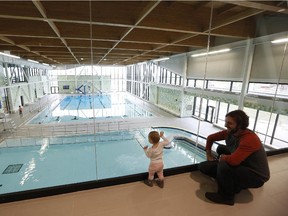 One-year-old Élise Black and father Thierry inspect the Minto Recreation Complex at its opening in south Barrhaven in late 2014. No corporate partner has come forward to help build a similar centre in Riverside South.