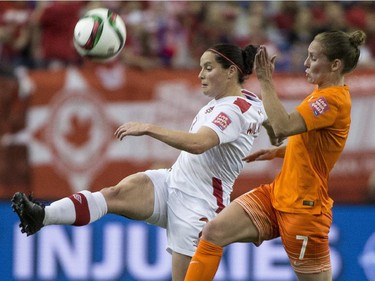 Canada's Emily Zurrer and Netherlands' Mano Melis battle for the ball during second half Women's World Cup soccer action Monday, June 15, 2015 in Montreal.