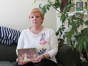 Maria Elisabeth Summers holds a photo of her wedding. Initially told she couldn't stay with her husband in England because of doubts their 45-year marriage was genuine, she now is being refused entry because the family income is too low.