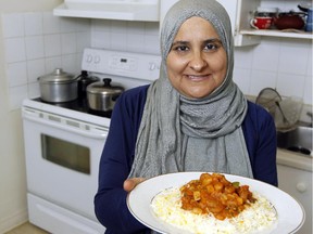 Mariam Rashid poses in her kitchen with one of the dishes she'll be making for eCelery customers to order for take-out Friday June 12, 2015. eCelery is an online service that offers people to order home-cooked ethnic cuisine.