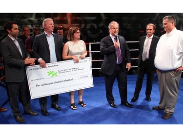 Michael McGahan, centre, joined by his sister, Sue, and the company's Oz Drewniak, left, Dave McGahan, Mike McCann and Dave Nevins, spoke briefly in the ring about the $1.5 donation made by CLV Group and the McGahan family to the Boys and Girls Club of Ottawa during Ringside for Youth XXI, held Thursday, June 11, 2015.