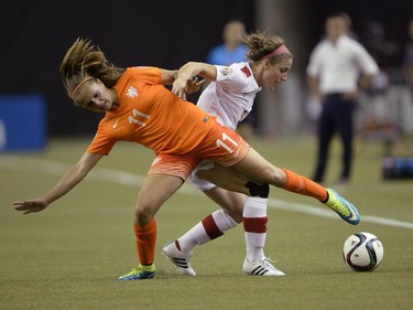 Netherlands' Lieke Martens (11) and Canada's Josee Belanger (9) battles for the ball during second half FIFA Women's World Cup soccer in Montreal on Monday, June 15, 2015.