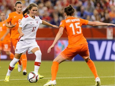 MONTREAL, QC - JUNE 15:  Jessie Fleming #17 of Canada tries to move the ball past Merel Van Dongen #15 of the Netherlands during the 2015 FIFA Women's World Cup Group A match at Olympic Stadium on June 15, 2015 in Montreal, Quebec, Canada.