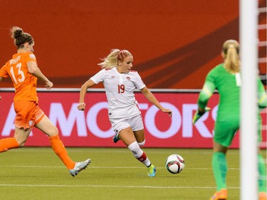 MONTREAL, QC - JUNE 15:  Adriana Leon #19 of Canada tries to get the ball past Dominique Janssen #13 of the Netherlands during the 2015 FIFA Women's World Cup Group A match at Olympic Stadium on June 15, 2015 in Montreal, Quebec, Canada.