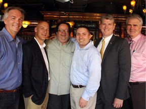 From left, Eric Kalbfleisch (sales rep, Royal LePage Team Realty), Rob Montgomery (branch general manager, Johnson Controls), Peter Simpson (arts editor-at-large, Ottawa Citizen), Brian Boucher (v-p of operations, Lee Valley Tools), Patrick McGarry (funeral director and COO, Hulse, Playfair & McGarry) and Keith Shea (advisor, Sun Life Financial), on Tuesday, June 23, 2015, at the Heart & Crown pub on Preston Street, are part of the 100 Men Who Care Ottawa group of men who are giving back to their community.