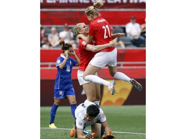 Norway's Elise Thorsnes (16) and Ada Hegerberg (21) celebrate Hegerber's goal against Thailand's Waraporn Boonsing (1) during the second half of their first match of the FIFA Women's World Cup at TD Place in Ottawa Saturday June 07, 2014. Norway won 4-0.