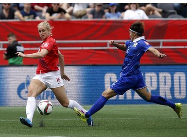 Norway's Elise Thorsnes (16) passes the ball while under pressure from Thailand's Natthakarn Chinwong (3) during the second half of their first match of the FIFA Women's World Cup at TD Place in Ottawa Saturday June 07, 2014. Norway won 4-0.