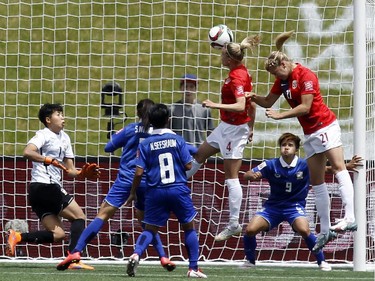 Norway's Gry Tofte IMS (4) and Ada Hegerberg (21) jump to head the ball against Thailand during the first half of their first match of the FIFA Women's World Cup at TD Place in Ottawa Sunday June 07, 2015.
