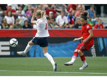 Norway's Gry Tofte IMS (4) tries to stop a shot by Celia Sasic (13) of Germany during the first half of their match during the 2015 FIFA Women's World Cup at Lansdowne Stadium Thursday June 11, 2015.