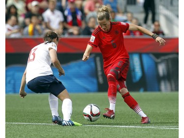 Norway's Ingrid Moe Wold (13) keeps her eye on the foot work of Germany's Simone Laudehr (6) during the first half of their match during the 2015 FIFA Women's World Cup at Lansdowne Stadium Thursday June 11, 2015.