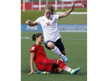 Norway's Ingrid Schjelderup (14) jumps over a sliding Dzsenifer Marozsan (10) of Germany during the second half of their match during the 2015 FIFA Women's World Cup at Lansdowne Stadium Thursday June 11, 2015. Germany and Norway tied 1-1.