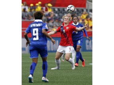 Norway's Isabell Herlovsen (9) watches a loose ball as Thailand's Warunee Phetwiset (9) and Pkul Khueanpet (6) look on during the second half of their first match of the FIFA Women's World Cup at TD Place in Ottawa Saturday June 07, 2014. Norway won 4-0.