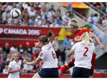 Norway's Maren Mjelde (6) and Maria Thorisdottir (2) can't stop a header attempt by Alexandra Popp (18) of Germany during the first half of their match during the 2015 FIFA Women's World Cup at Lansdowne Stadium Thursday June 11, 2015.