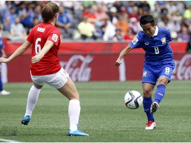 Norway's Maren Mjelde (6) defends a shot by Thailand's Naphat Seesraum (8) during the first half of their first match of the FIFA Women's World Cup at TD Place in Ottawa Sunday June 07, 2015.