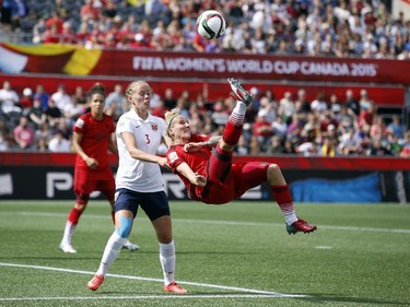 Norway's Marita Skammelsrud Lund (3) defends a bicycle-kick attempt by Germany' s Anja Mittag (11) during the first half of their match during the 2015 FIFA Women's World Cup at Lansdowne Stadium Thursday June 11, 2015.