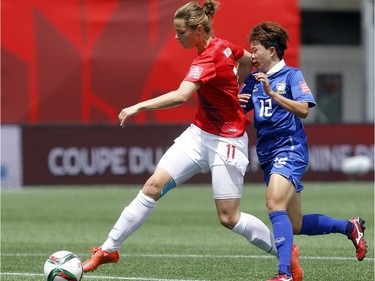 Norway's Nora Holstad Bergen (11) defends the ball against an attacking Rattikan Thongsombut (12) of Thailand during the first half of their first match of the FIFA Women's World Cup at TD Place in Ottawa Sunday June 07, 2015.