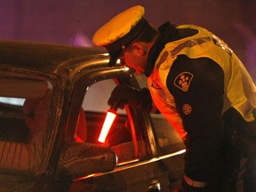 Sergeant Don Hickey interviews drivers during a ride program at the Maitland 417 west bound ramp in Ottawa, December 22, 2009.