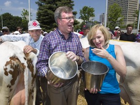 City slickers Mayor Jim Watson and Laureen Harper get in touch with their roots at the 2013 Food Fair/Rural Expo.