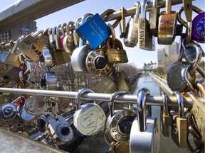Discarded locks of lovers and others hang on the Corkstown Bridge over the Rideau Canal as the city of Ottawa basks in sunshine.