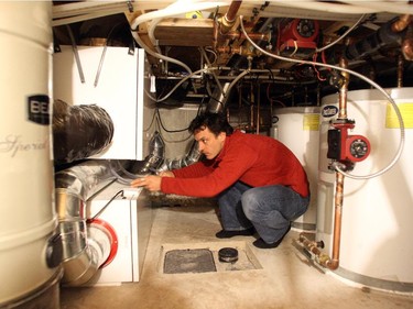 Straka, shown checking out his home’s mechanical systems, says there’s no comparison in comfort between living in a passive and conventional home.