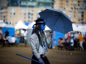 Doug Wagner shows off his blue side, a regular at the festival, wanders the grounds Saturday July 12, 2013 at Ottawa Bluesfest.   (Ashley Fraser for The Ottawa Citizen)