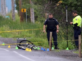 Ottawa police investigate a fatal early morning hit and run collision involving a cyclist on Leitrim Rd. near Albion Rd Sunday, June 28, 2015.