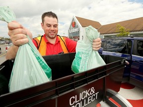 Personal Shopper, Paul Aspeck, loads groceries into a car at the designated Click-and-Collect spots outside the Barrhaven Loblaw's store.