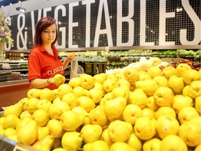 Personal Shopper, Rachel Fairservice picks out groceries in the produce section at the Barrhaven Loblaw store.